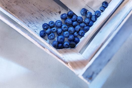 Blueberries  or bilberries in wooden box ,  blue berries  fruit in crate , healthy eating