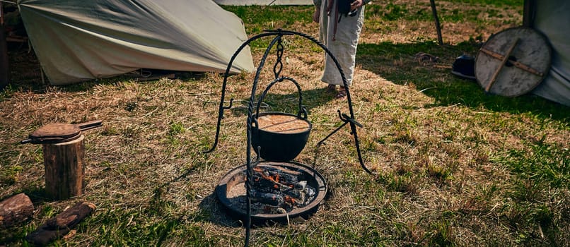 Camping. Soup in a pot over a fire. Stylization under the Middle Ages, vintage.