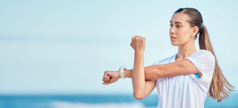 Woman, arm and stretching by beach on mockup space in fitness, motivation or outdoor workout. Female person or runner in body warm up on ocean coast, banner or sports for healthy wellness or training.