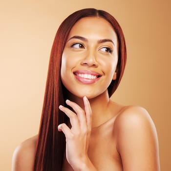 Hair care, beauty and portrait of happy woman with glow, hand on skin and luxury salon treatment on brown background. Smile, haircut and haircare, face of model with cosmetics and makeup in studio