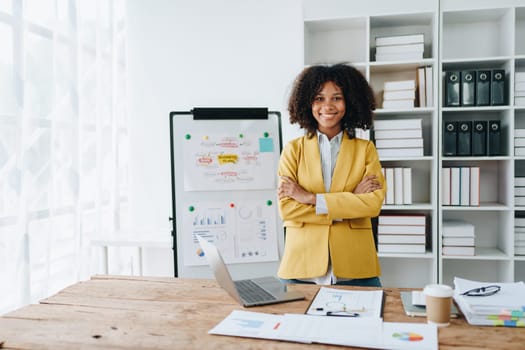 American African business woman using document, computer laptop, calculator, paperwork, documents, in winner and smiling Happy to be successful achievement success. finance and investment concepts.