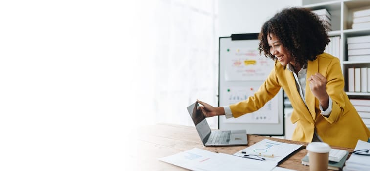 American African business woman using document, computer laptop, calculator, paperwork, documents, in winner and smiling Happy to be successful achievement success. finance and investment concepts.