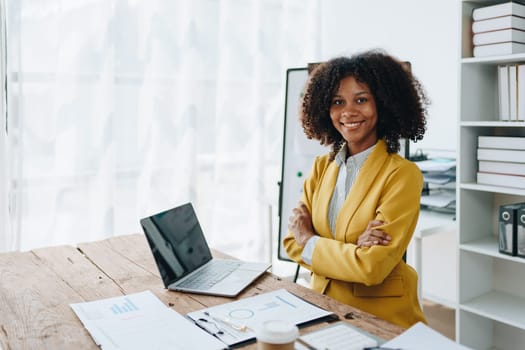 American African business woman using document, computer laptop, calculator, paperwork, documents, in winner and smiling Happy to be successful achievement success. finance and investment concepts.