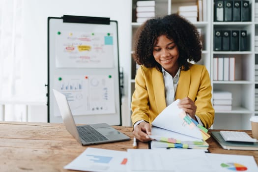 financial, Planning, Marketing and Accounting, portrait of african american employee checking financial statements using documents and calculators at work.