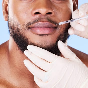 Man, plastic surgery and needle in studio for lips, filler and beauty for face transformation by background. African patient, model or surgeon hands for skincare, syringe or dermatology for aesthetic.
