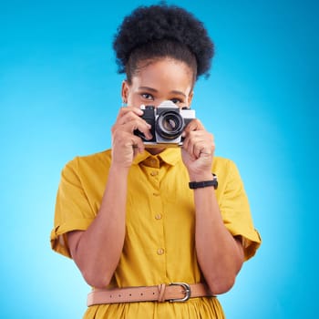 Photography, portrait and black woman with camera isolated on blue background, creative artist job talent. Art, face of happy photographer with hobby or career in studio on travel holiday photoshoot