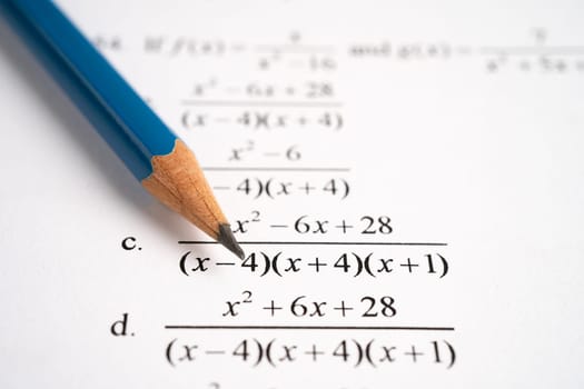 Pencil on mathematic formula exercise test paper in education school.