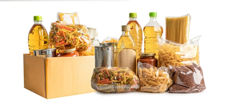 Foodstuff for donation, storage and delivery. Various food, pasta, cooking oil and canned food in cardboard box.