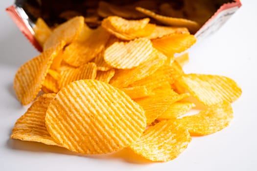 Potato chips, delicious BBQ seasoning spicy for crips, thin slice deep fried snack fast food in open bag.