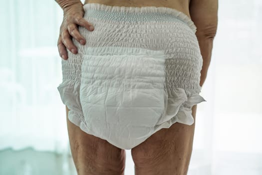 Asian senior woman patient wearing incontinence diaper in hospital, healthy strong medical concept.