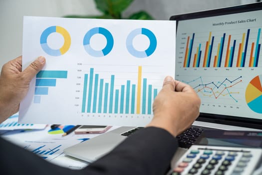 Asian accountant working and analyzing financial reports project accounting with chart graph in modern office, finance and business concept.