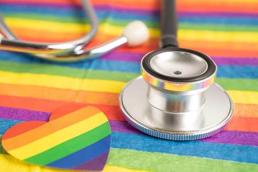 Black stethoscope on rainbow flag with heart, symbol of LGBT pride month celebrate annual in June social, symbol of gay, lesbian, bisexual, transgender, human rights and peace.