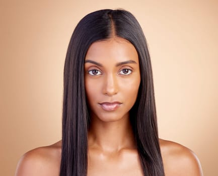 Portrait, hair care and Indian woman with beauty, cosmetics or texture on a brown studio background. Face, female person or model with cosmetology, shine or scalp treatment with aesthetic or skincare.