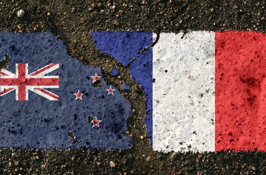 On the pavement are images of the flags of New Zealand and France, as a symbol of confrontation. Conceptual image.