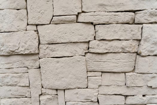 Close-up of a painted textured gray stone wall.
