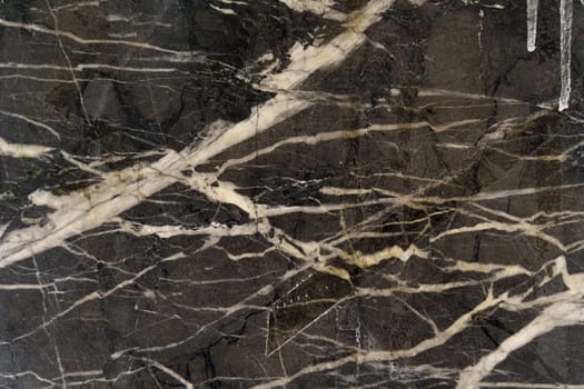 Texture of black marble with white veins.