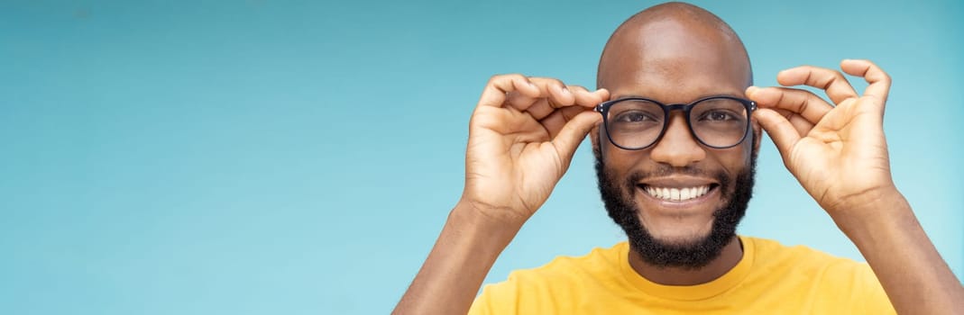 Black man, portrait or vision glasses on blue background, isolated mockup or wall mock up for eyes care, retail or sales deal. Smile, happy or face and fashion optometry for lens healthcare wellness.
