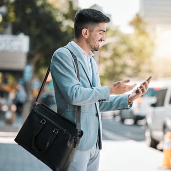 Phone, app and a business man in the city for travel on his morning commute into work during summer. Mobile, social media or networking with a happy young male employee on an urban street in town.