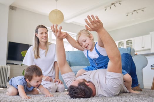 Happy family, parents and children on floor playing, bonding and airplane game time in living room. Home, love and playful energy, mom and dad with kids on carpet, laughing and relax with happiness