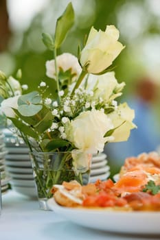 Composition of fresh flowers on a festive wedding table. Elegance wedding decor. Selective focus.