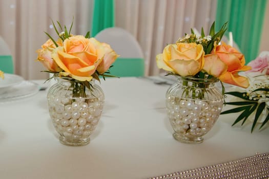 Composition of fresh flowers on a festive wedding table. Elegance wedding decor. Selective focus.