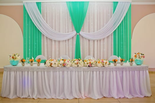 Wedding table with favors and flowers. Elegance wedding decor.