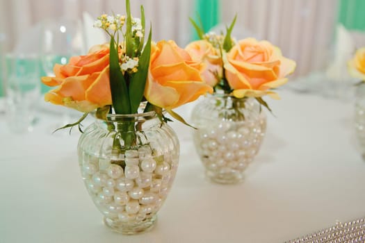 Composition of fresh flowers on a festive wedding table. Elegance wedding decor. Selective focus.