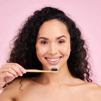 Woman, wood toothbrush and studio portrait for dental wellness, cosmetics and healthy mouth by pink background. Girl, model and natural toothpaste for teeth whitening, self care and dentistry product.