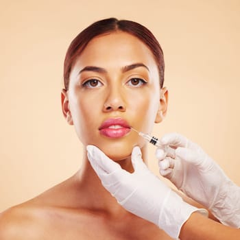 Portrait, woman or plastic surgery with a needle, lip filler and cosmetics isolated on studio background. Hands, lips or face of model with injection, dermatology and beauty with medical procedure.
