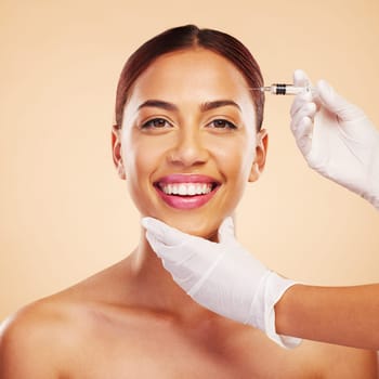 Portrait, happy woman or plastic surgery with a needle, cosmetics isolated on studio background. Hands, forehead or face of model with injection, smile or beauty in dermatology medical procedure.