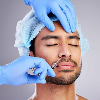 Hands, facelift and plastic surgery with a man in studio on a gray background for a botox injection. Face, change and transformation with a male customer in a clinic for beauty or antiaging filler.