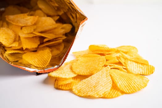 Potato chips, delicious BBQ seasoning spicy for crips, thin slice deep fried snack fast food in open bag.