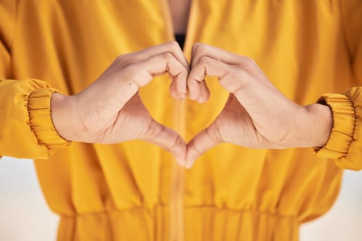 Woman, heart hands and love for care, support or trust in healthcare, romance or gesture. Closeup of female person with emoji, symbol or icon for health, like or wellness in peace, sign or emoticon.