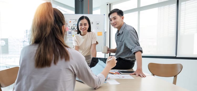 Asian office team brainstorming, plan for solution idea, Group of asia creative teamwork and woman leader at business meeting for developing mobile phone app, ux, ui start up, small business.