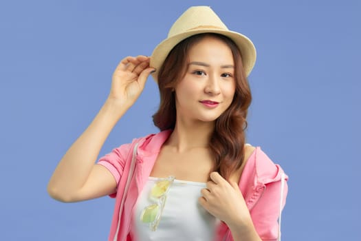 Asian pretty woman tourist preparing for travel on blue background