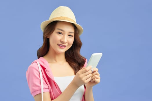 Asian pretty woman tourist preparing for travel and using smartphone isolated on blue banner background.