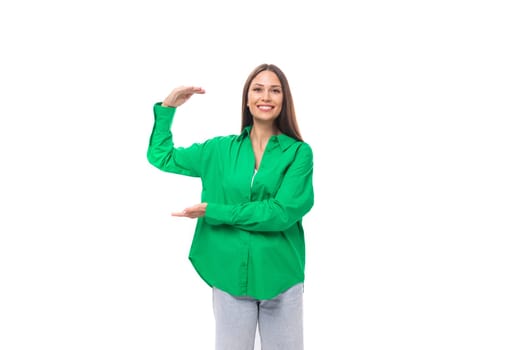 attractive young brown-haired female model with brown eyes in green shirt isolated on white background.