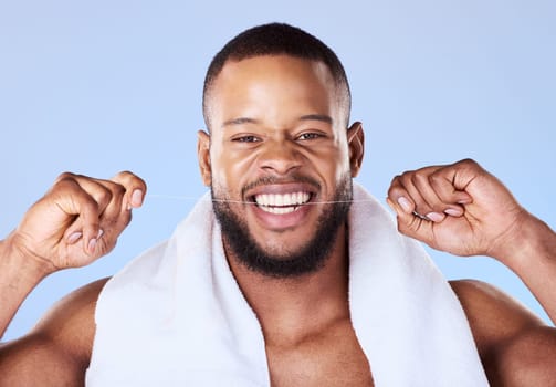 Portrait, man and floss teeth for smile, dental health and care for gum gingivitis in studio. Face of happy black male model, oral thread and cleaning mouth for fresh breath, tooth hygiene and beauty.