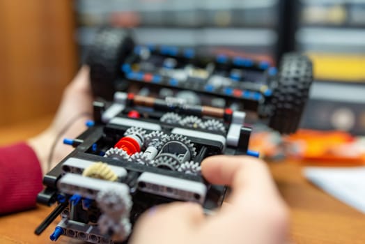 Little boy playing with engineering set for making different machines