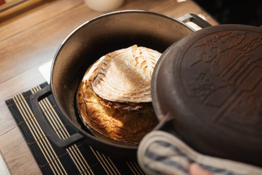 Opening cap of a pot with fresh aromatic self made bread inside