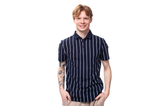 fashionable young white-haired man in a blue polo with tattoos.