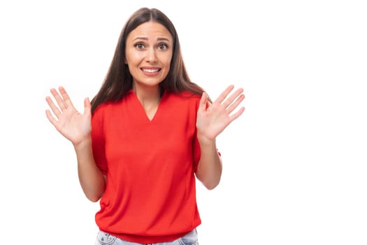 young attractive brunette woman in a red stylish v-neck blouse filled her arms in surprise.