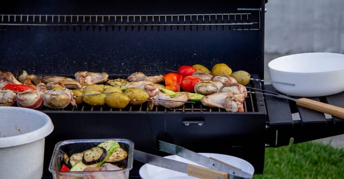 a man is grilling vegetables and meat. Selective focus. Nature