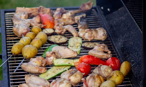 a man is grilling vegetables and meat. Selective focus. Nature