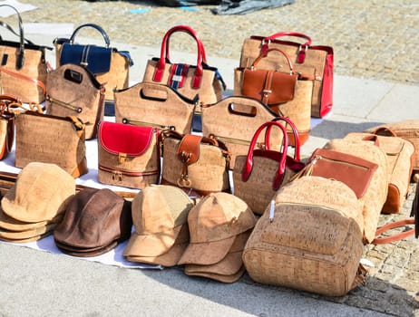 Variety of bags and souvenirs made from oak cork at the street market at Lisbon, Portugal. Porto