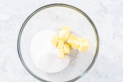 Mixing ingredients in a glass mixing bowl to bake July 4th bundt cake with chocolate stars.