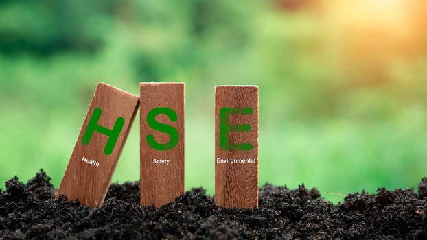 Wooden sticks stacked with HSE concept lettering on nature background. Concept of HSE Health Safety Environment Education Industry.words HSE on a woodblock It is an idea for health safety environment for business and organization.