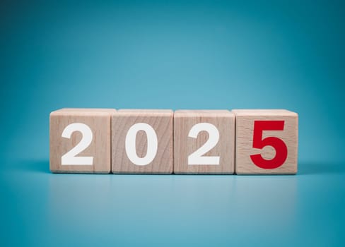 Wooden blocks lined up with the letters 2025. Represents the goal setting for 2025, the concept of a start. financial planning development strategy business goal setting