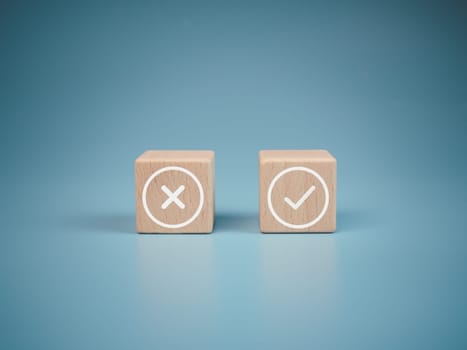 Wooden blocks with wrong and right symbols on light blue background.