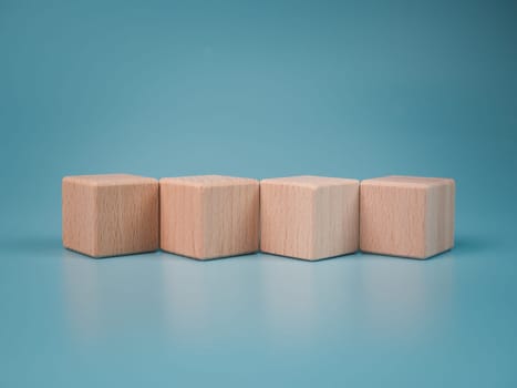 empty wooden blocks lined up on light blue background. Business concept,object.